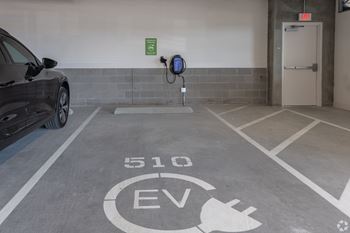 a parking garage with a car and a gas pump at Aura Vegas Apartments, Las Vegas, Nevada